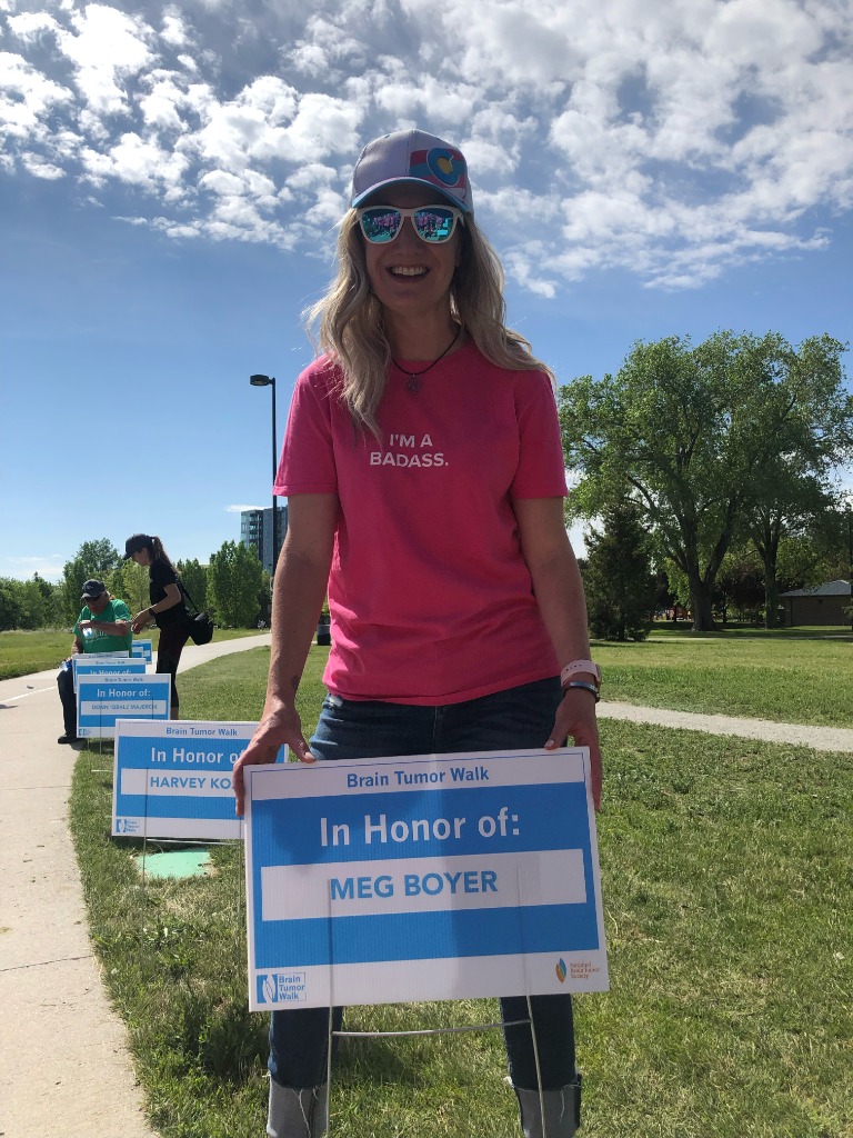 Meg Boyer holding Brain Tumor Walk sign in her honor